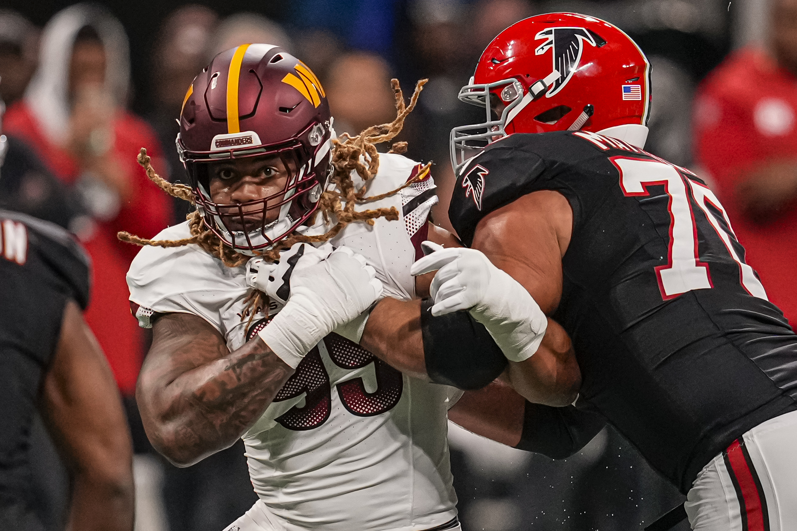 Washington Commanders defensive end Chase Young (99) battles with Atlanta Falcons offensive tackle Jake Matthews.
